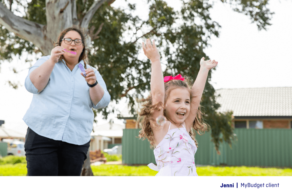 A single mum with her daughter blowing bubbles outdoors