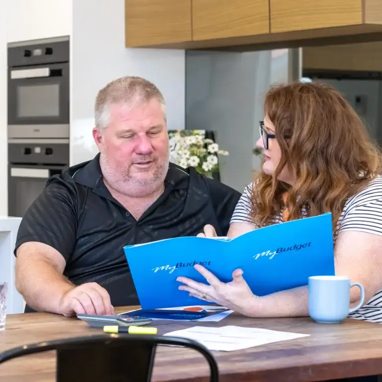 MyBudget clients Alyssa and Pete organizing bills with a dedicated debt management plan and budget planning in Australia.
